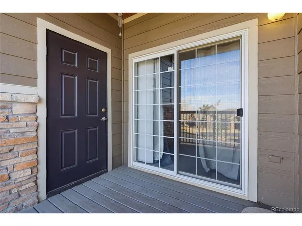 a view of wooden door and brick walls
