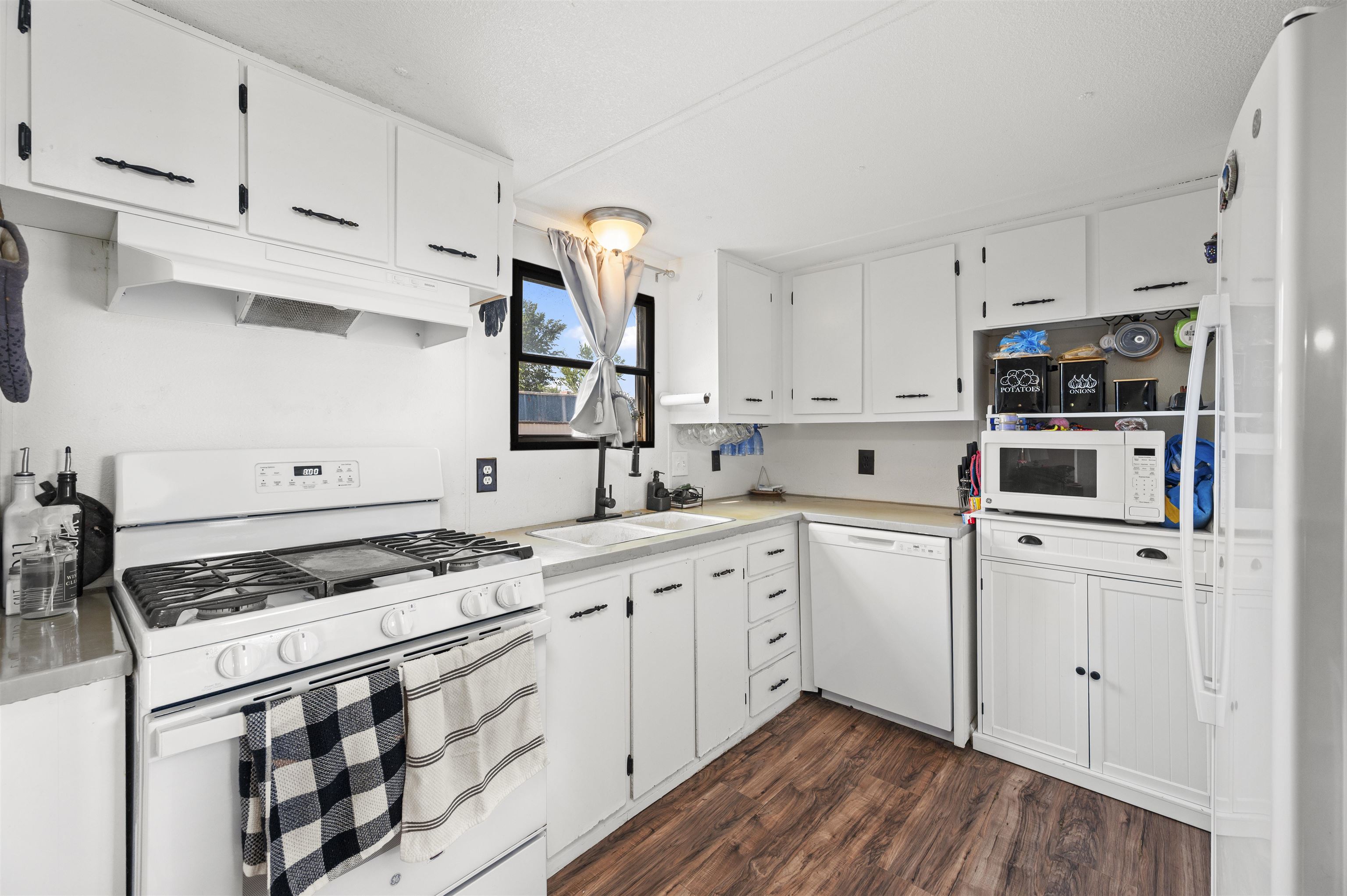 424 32 Road, Unit 6 Clifton, CO 81520 - Photo 8 of 16 a kitchen with cabinets appliances and a wooden floor