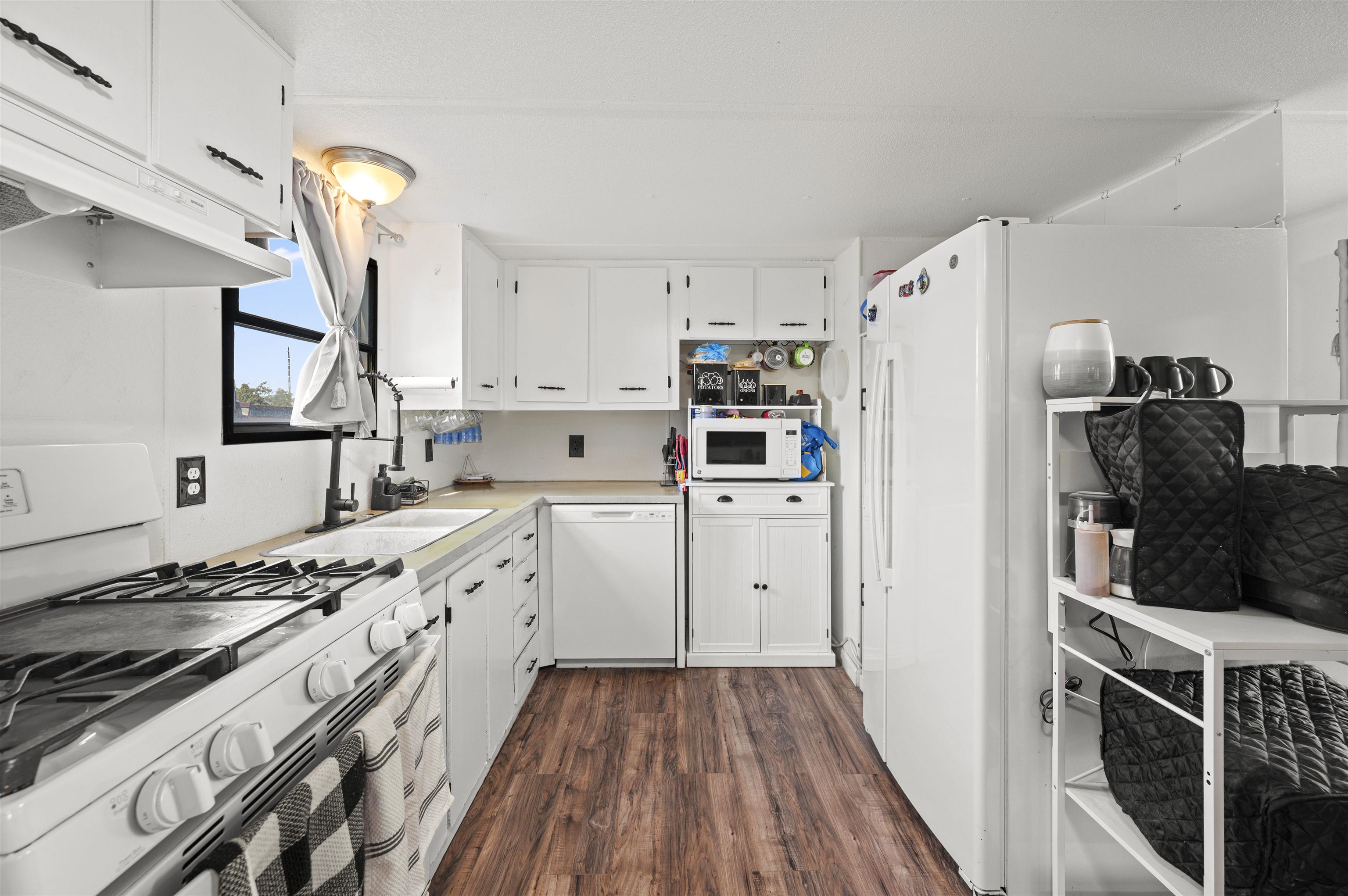 424 32 Road, Unit 6 Clifton, CO 81520 - Photo 9 of 16 a kitchen with stainless steel appliances a refrigerator a stove and white cabinets