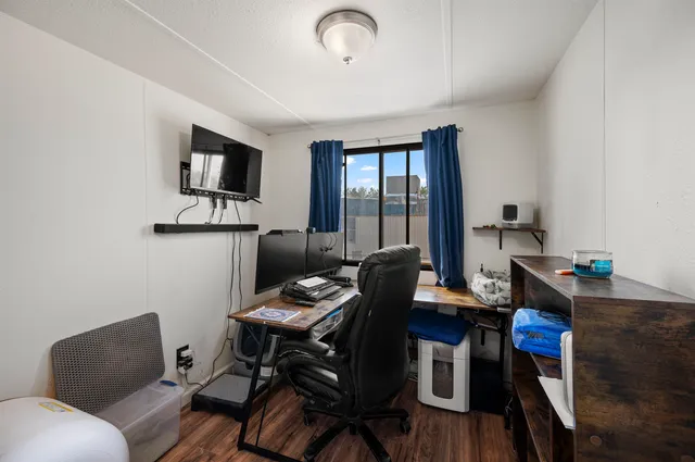 a work room with furniture and wooden floor