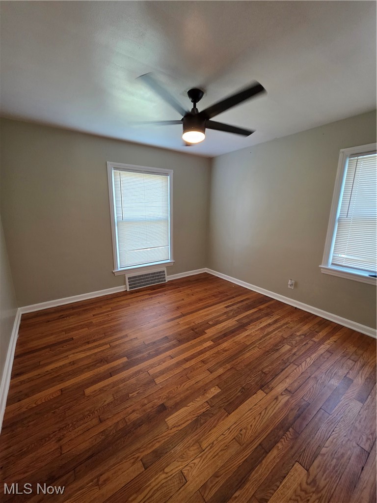 12813 North Road Cleveland, OH 44111 - Photo 13 of 30 Empty room featuring dark wood-type flooring and a ceiling fan