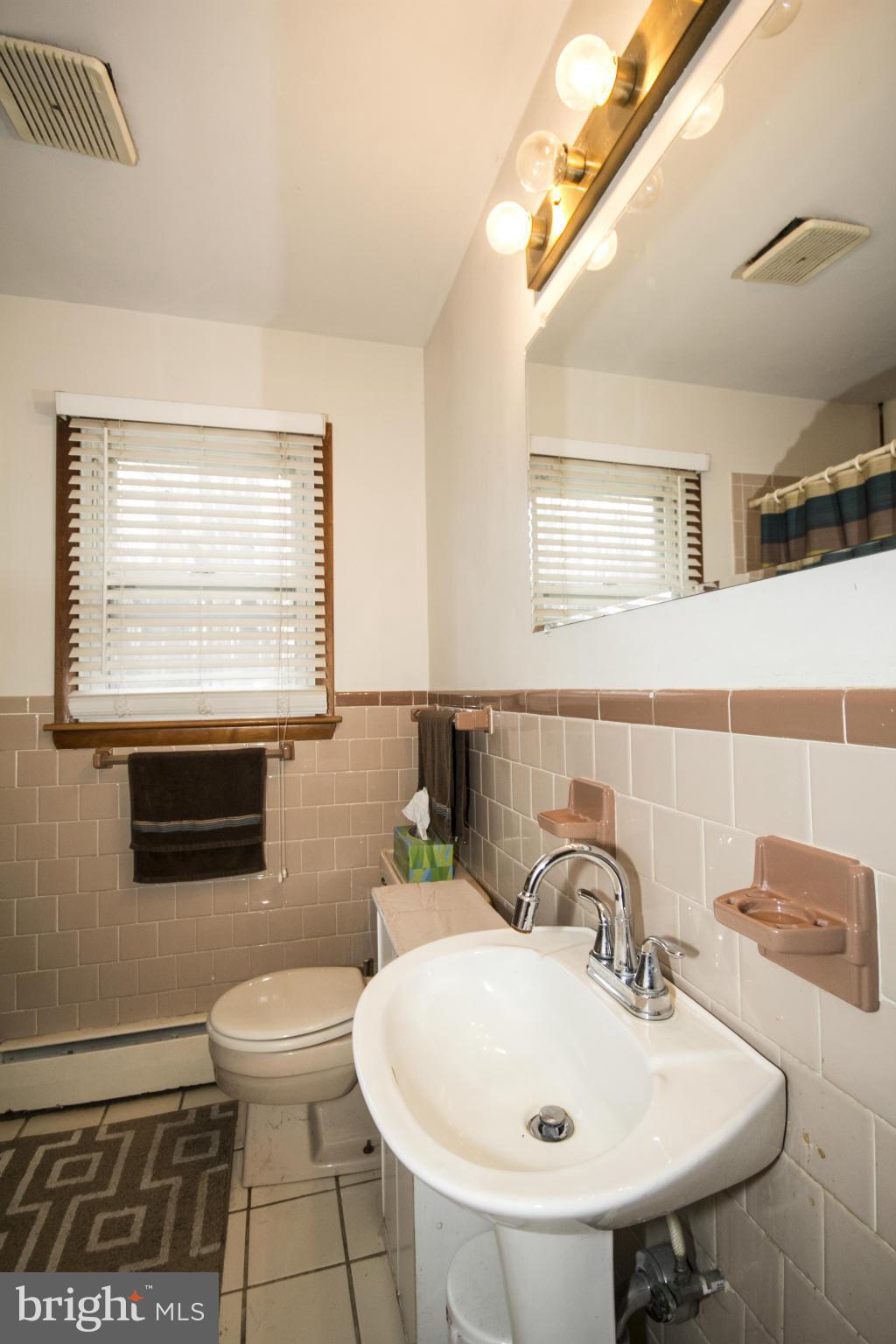 5024 Kemp Road Reisterstown, MD 21136 - Photo 12 of 30 a bathroom with a sink a toilet and mirror