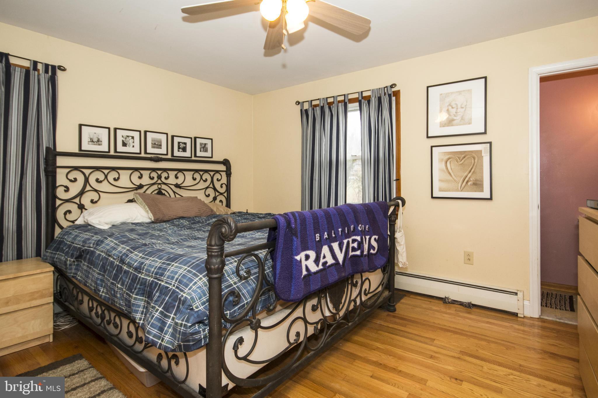 5024 Kemp Road Reisterstown, MD 21136 - Photo 15 of 30 a bedroom with a bed and wooden floor