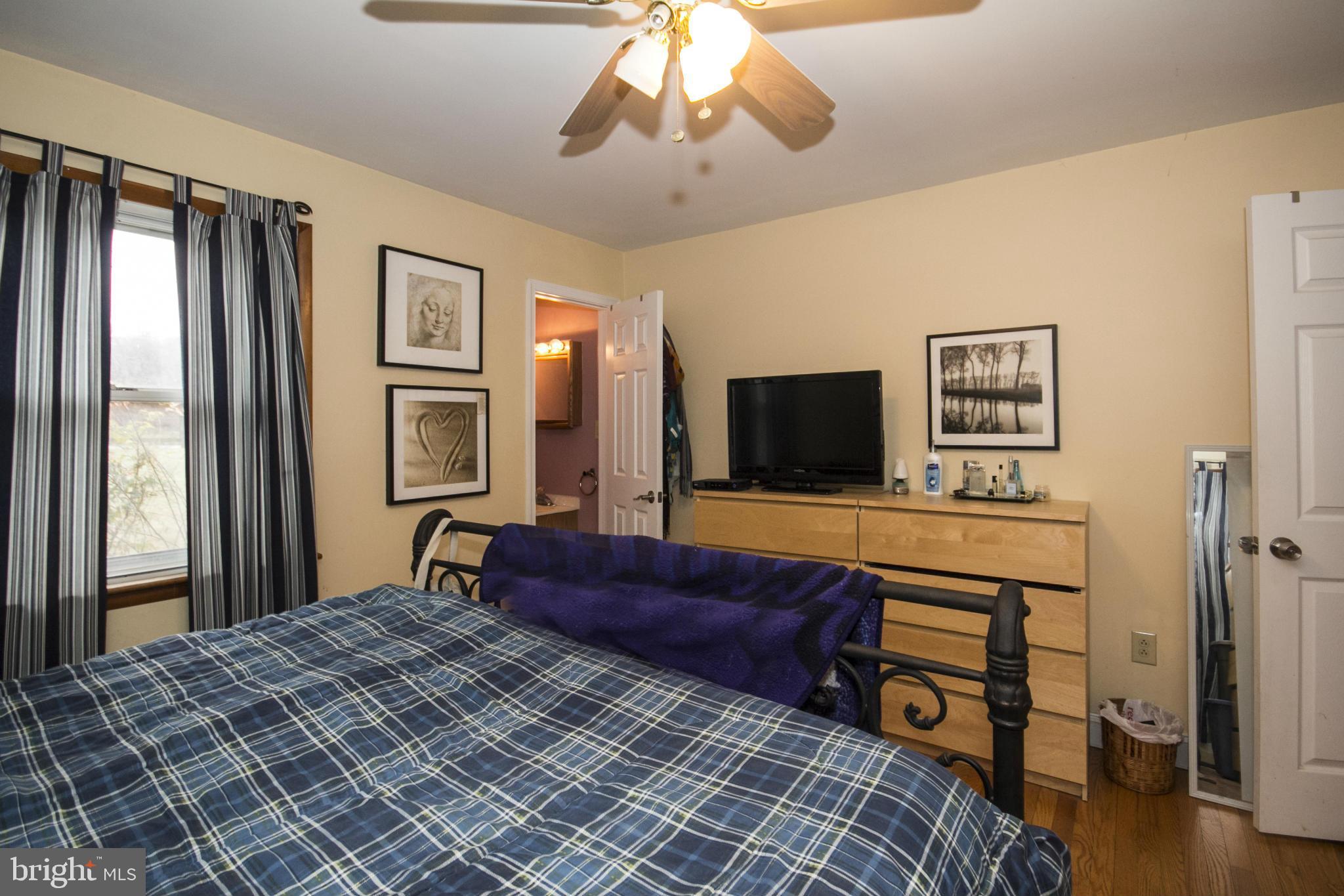 5024 Kemp Road Reisterstown, MD 21136 - Photo 16 of 30 a bedroom with a bed and a flat screen tv