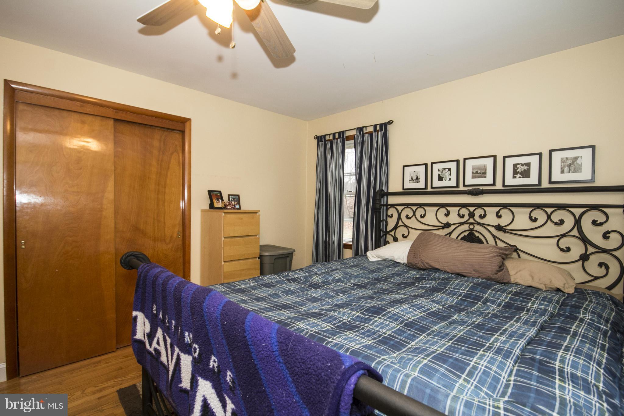 5024 Kemp Road Reisterstown, MD 21136 - Photo 17 of 30 a bedroom with a large bed and a chandelier