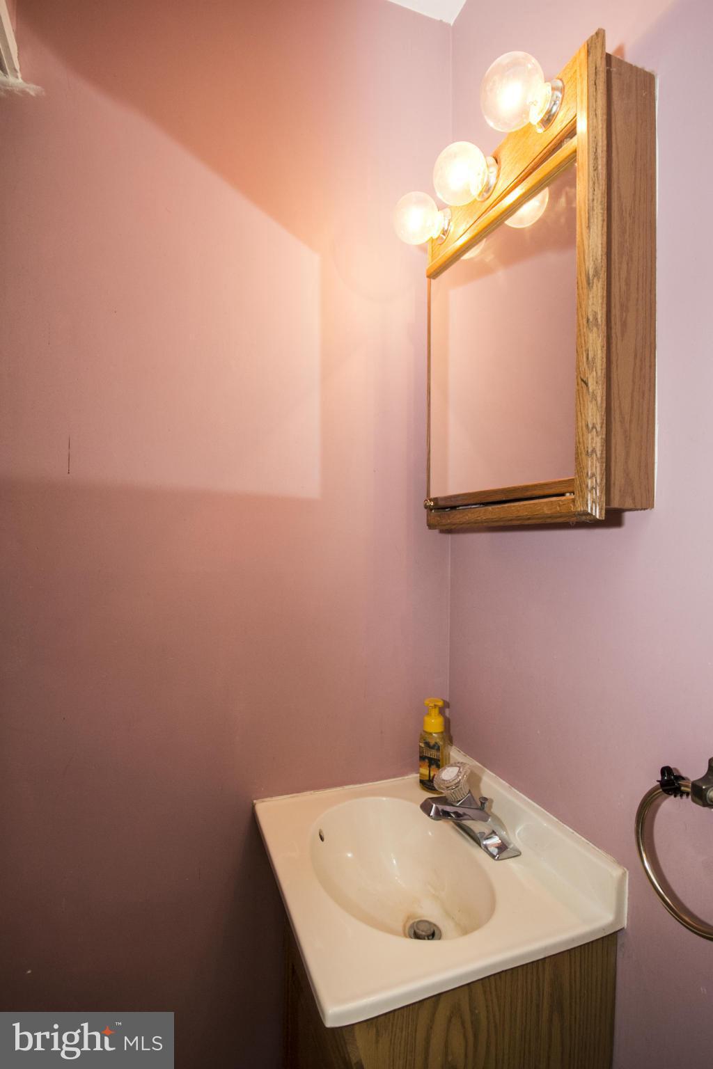 5024 Kemp Road Reisterstown, MD 21136 - Photo 18 of 30 a bathroom with a sink a mirror and a toilet