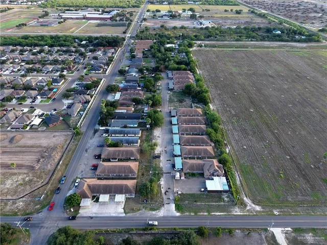 an aerial view of a house with a mountain