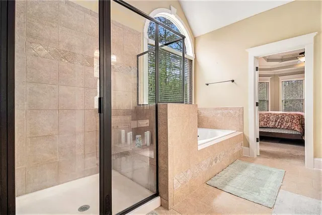 a bedroom with a bed and a large window