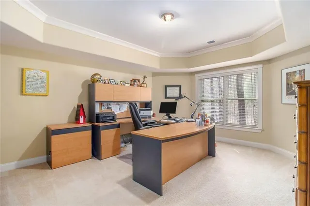 a view of a house with a small yard and wooden fence