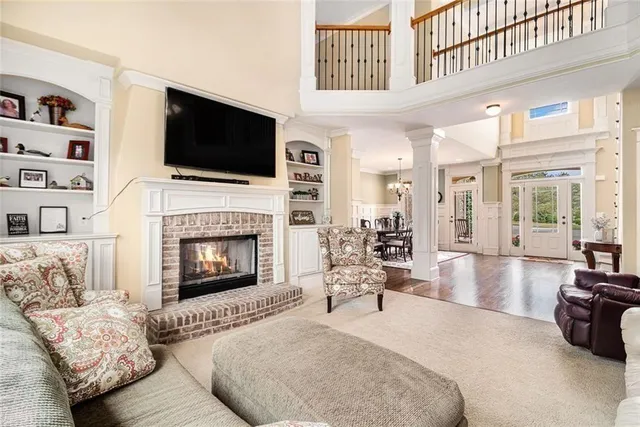 a dining room with furniture a chandelier and wooden floor