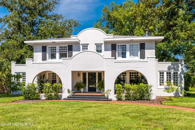a front view of a house with a garden