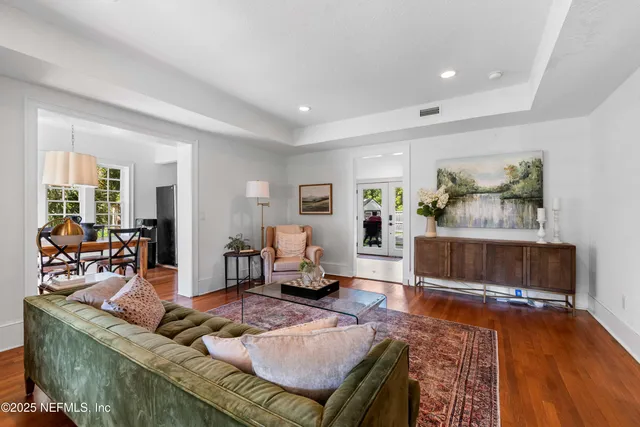 a living room with furniture and a wooden floor