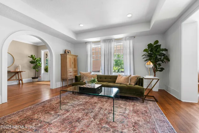 a living room with furniture and a potted plant