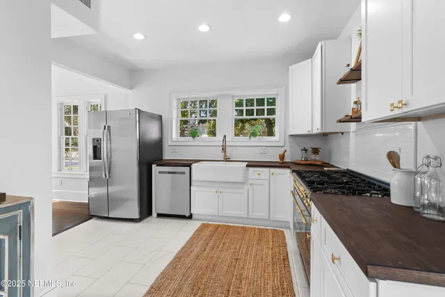 a kitchen with a refrigerator a sink and a stove