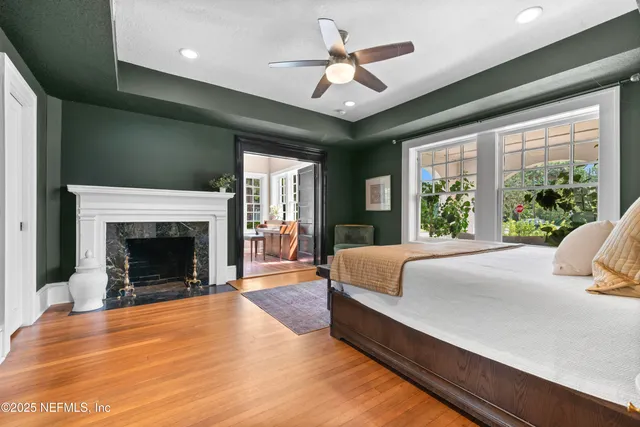 a bedroom with a large bed and a chandelier
