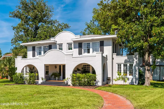 a front view of a house with garden