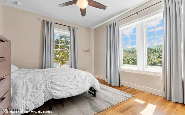 a bathroom with a granite countertop sink a mirror and a bathtub