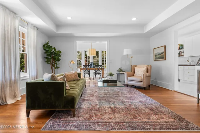 a living room with furniture and a potted plant