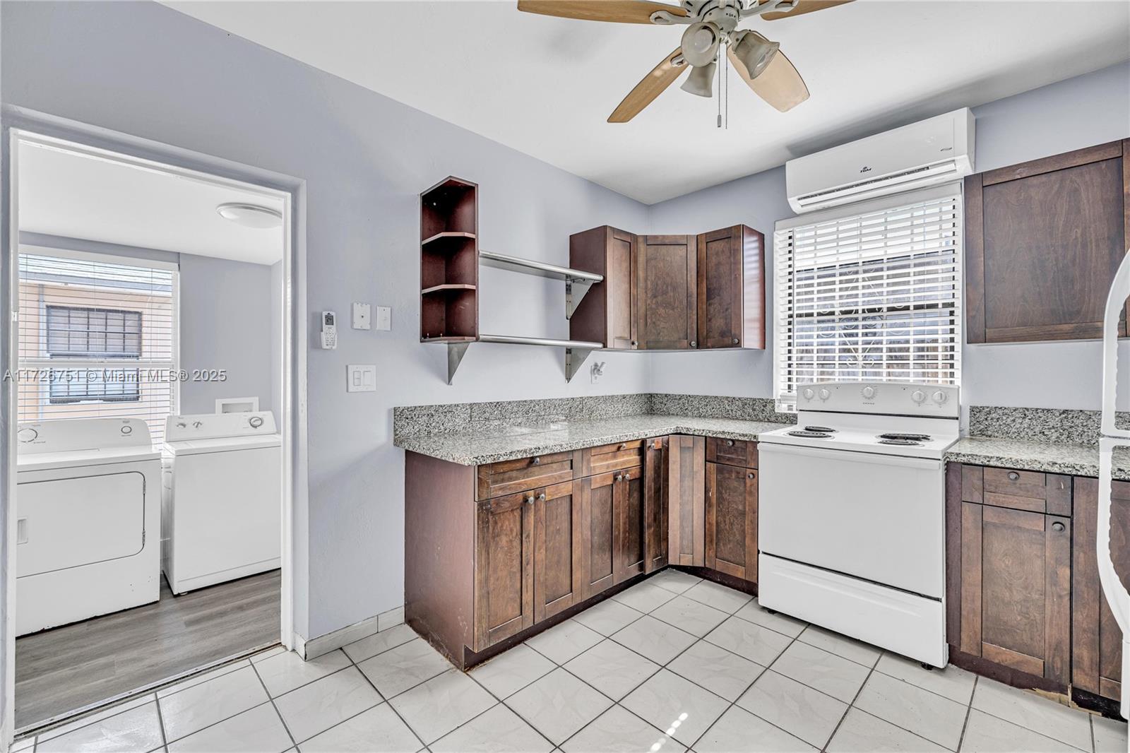 319 Northeast 171 Street North Miami Beach, FL 33162 - Photo 16 of 31 a kitchen with stainless steel appliances granite countertop a sink and a stove top oven