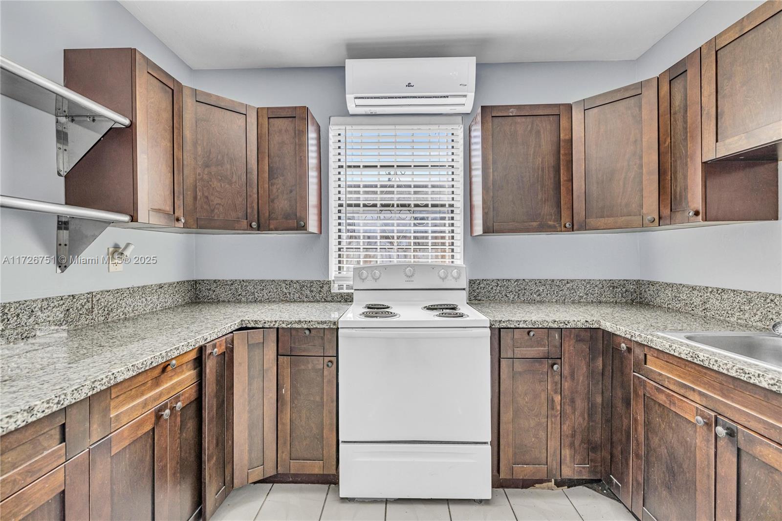 319 Northeast 171 Street North Miami Beach, FL 33162 - Photo 18 of 31 a kitchen with a sink stove and cabinets