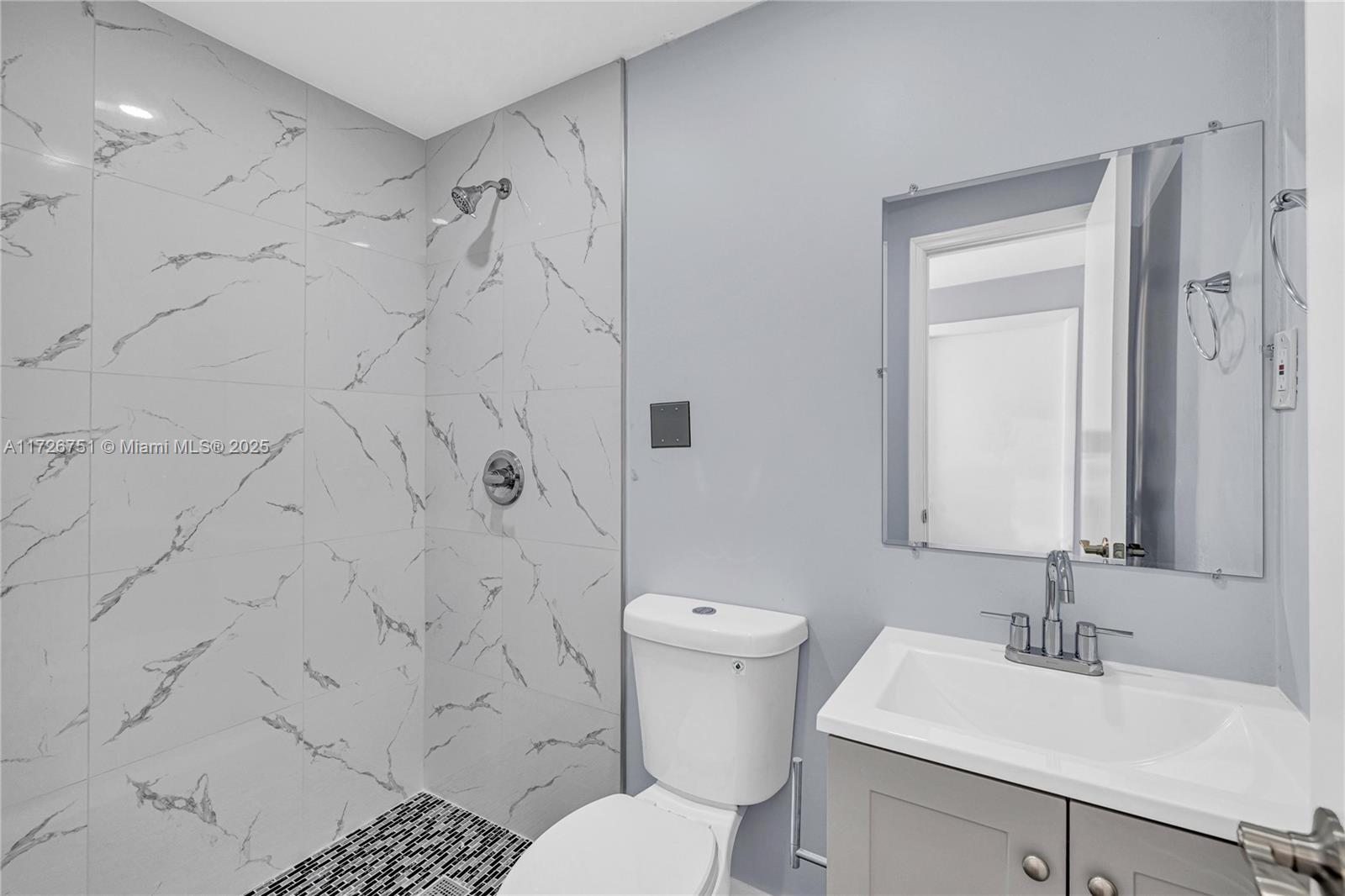 319 Northeast 171 Street North Miami Beach, FL 33162 - Photo 20 of 31 a bathroom with a sink toilet and shower