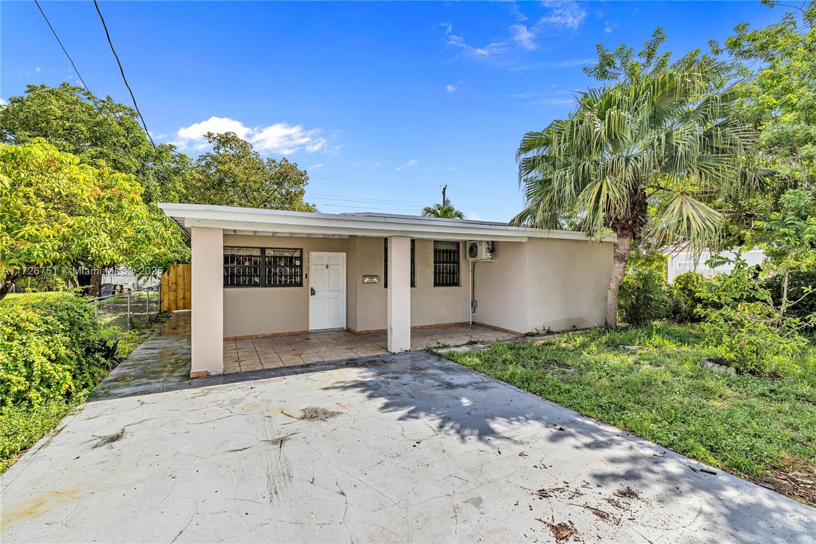 319 Northeast 171 Street North Miami Beach, FL 33162 - Photo 2 of 31 a view of a house with a yard