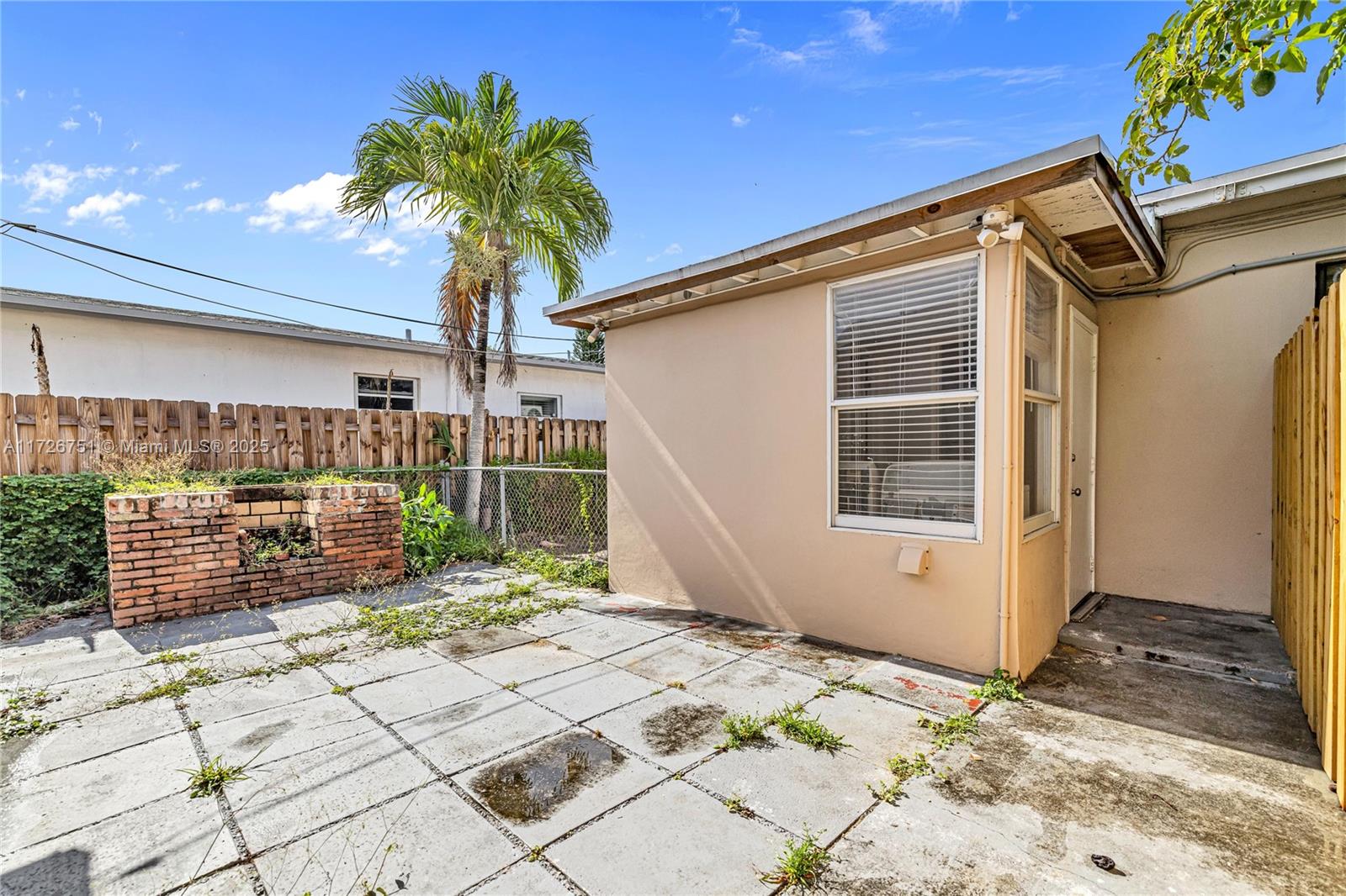 319 Northeast 171 Street North Miami Beach, FL 33162 - Photo 22 of 31 a potted plant sitting in front of a house