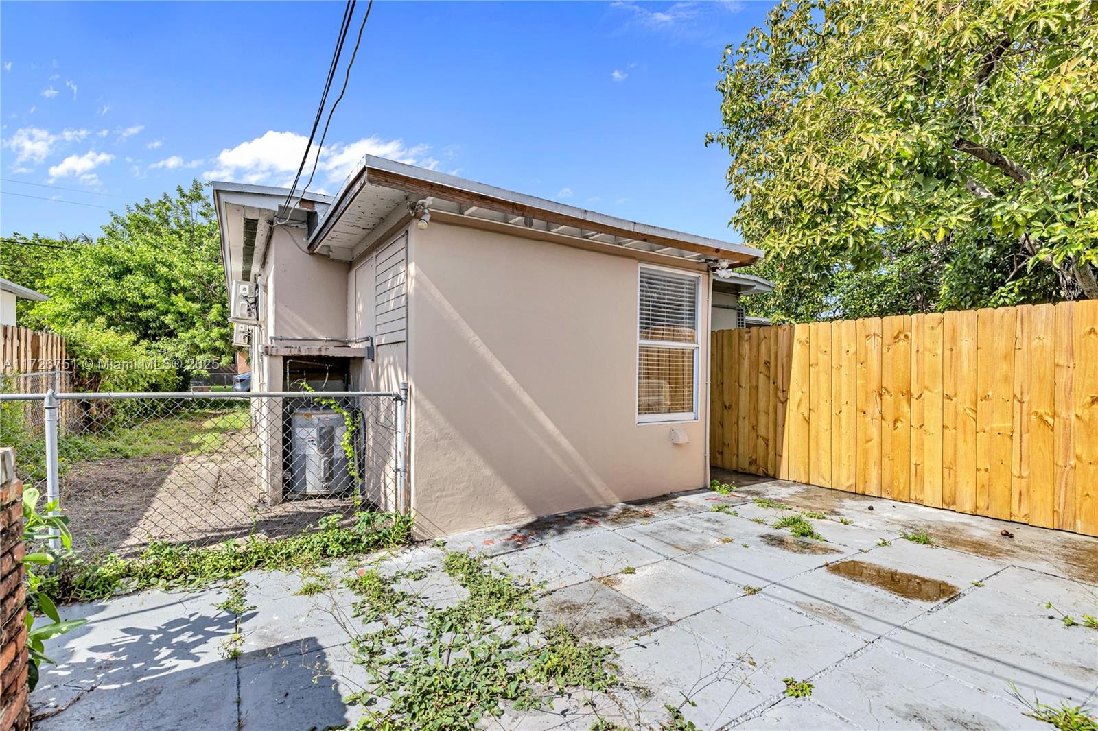 319 Northeast 171 Street North Miami Beach, FL 33162 - Photo 23 of 31 a backyard of a house with table and chairs