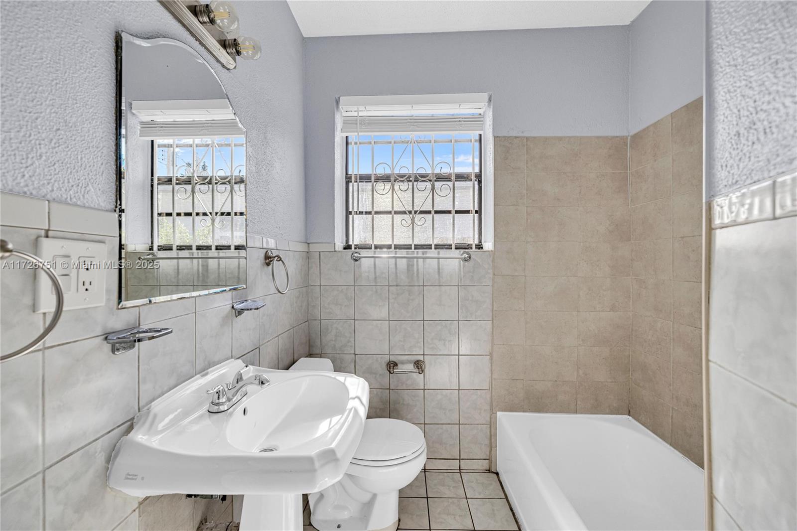 319 Northeast 171 Street North Miami Beach, FL 33162 - Photo 26 of 31 a bathroom with a sink toilet and shower