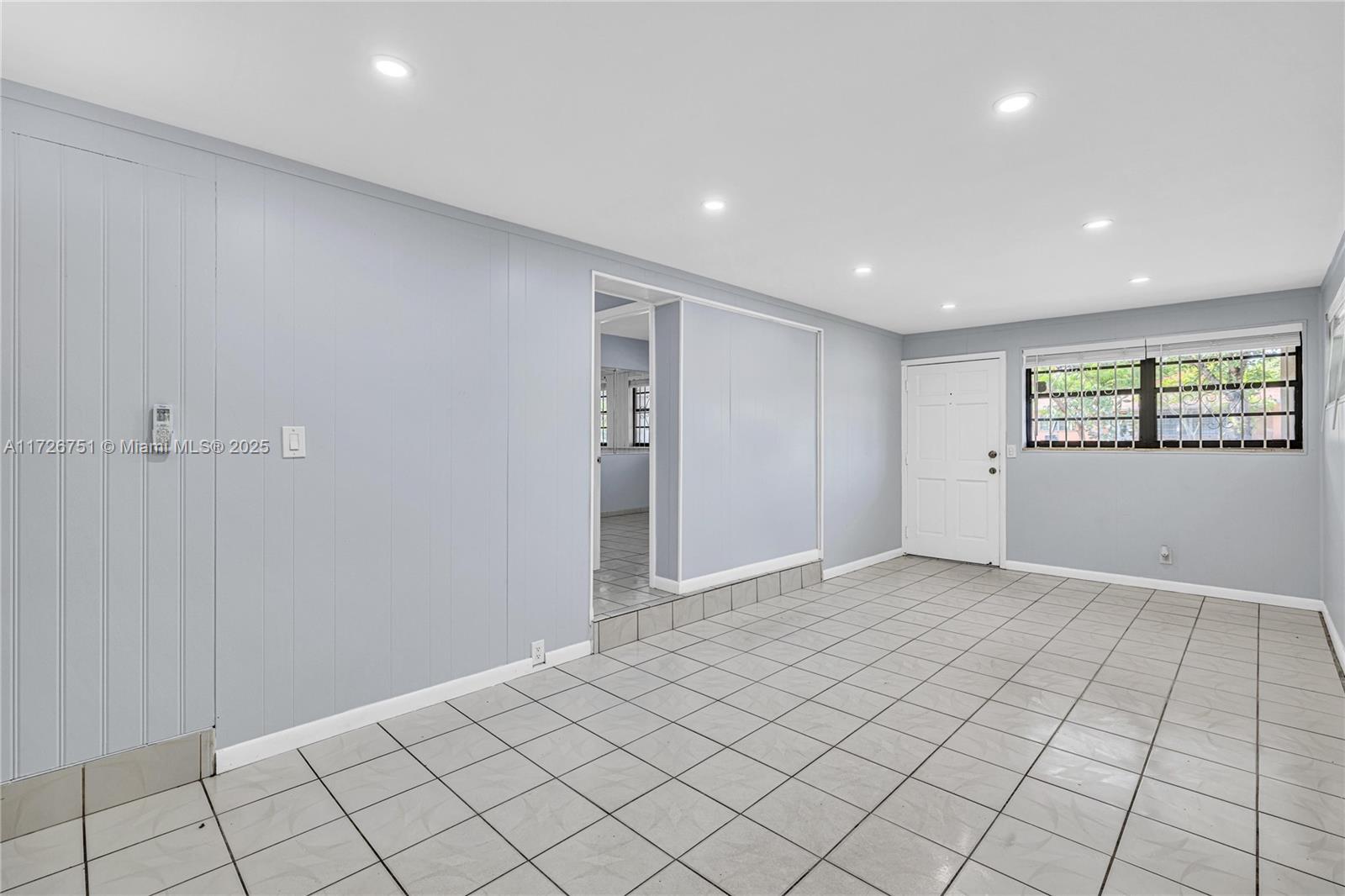 319 Northeast 171 Street North Miami Beach, FL 33162 - Photo 5 of 31 a view of an empty room and window