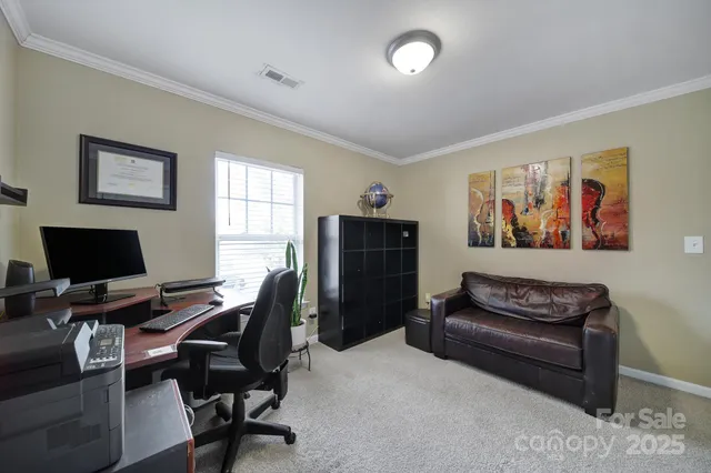 a view of a livingroom with workspace and a couch