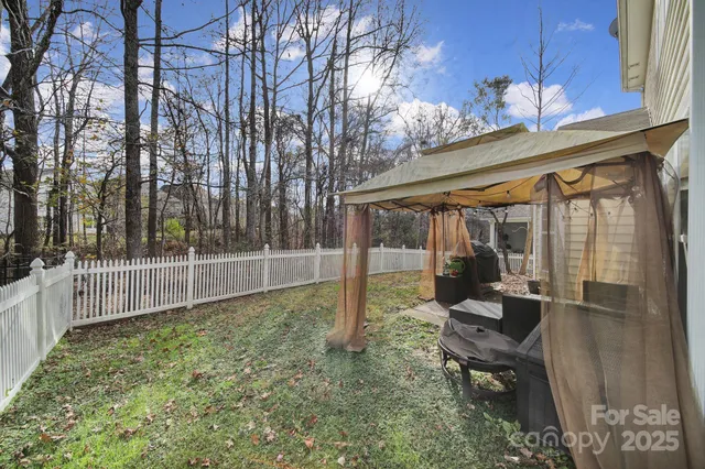 a view of a house with backyard and porch
