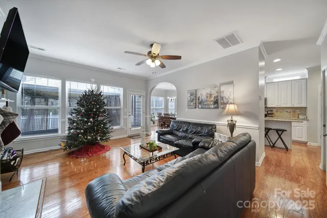 a living room with furniture ceiling fan and a fireplace