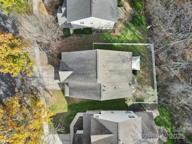 an aerial view of a house with a yard