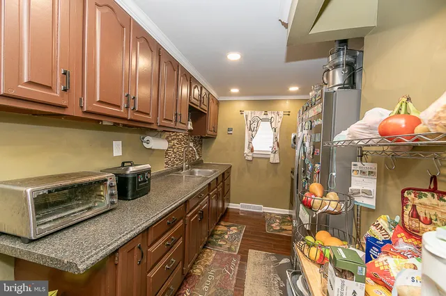 a kitchen with stainless steel appliances granite countertop a stove a sink dishwasher and cabinets