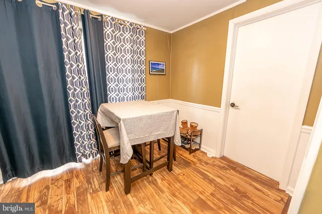 a dining room with furniture and wooden floor