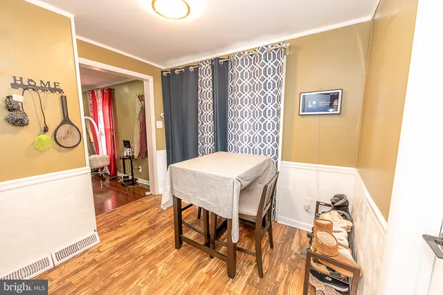 a view of a dining room with furniture and wooden floor