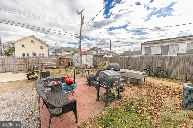 a roof deck with table and chairs