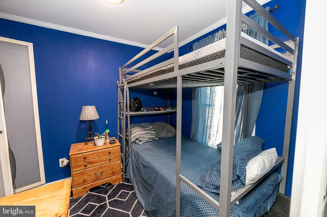 a bedroom with a bed and small closet