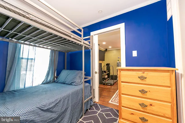 a bedroom with a bed and a dresser