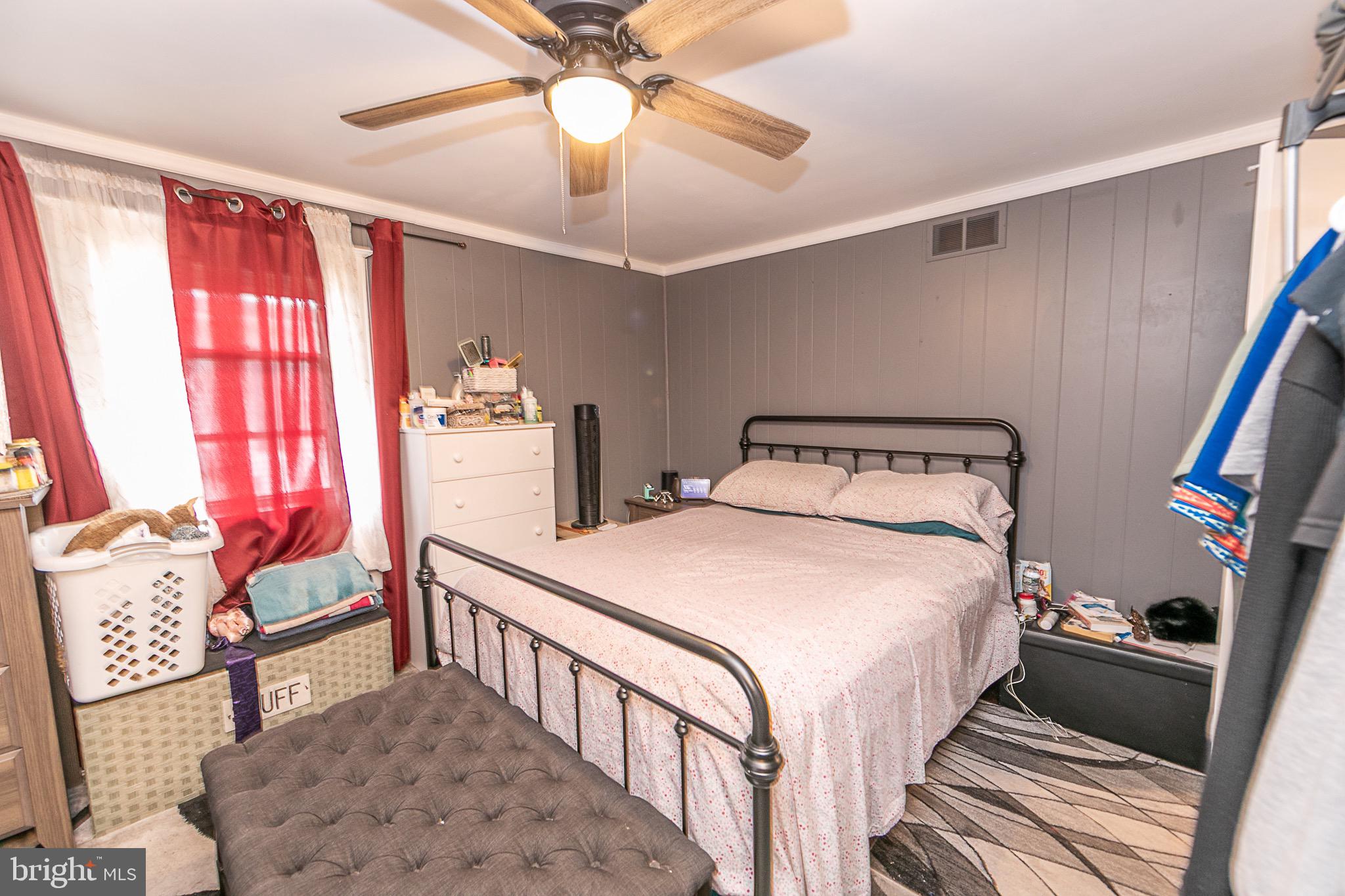 287 Jefferson Street Carneys Point, NJ 08069 - Photo 9 of 31 a bedroom with a bed and a chandelier