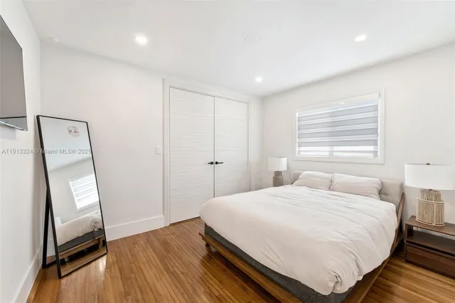 a bedroom with a bed and a mirror