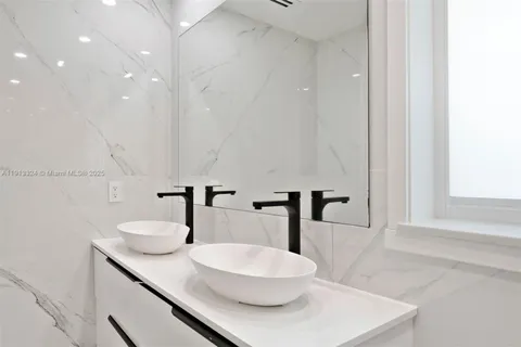 a bathroom with a double vanity sink and mirror