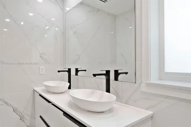 a bathroom with a double vanity sink and mirror