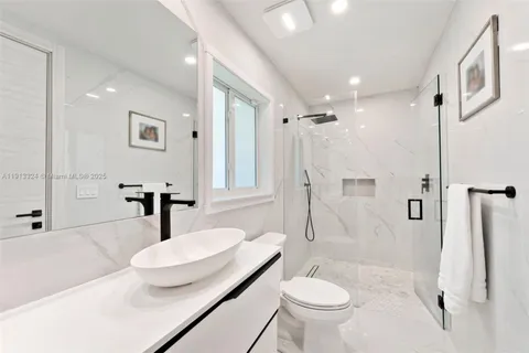 a bathroom with a sink toilet and shower