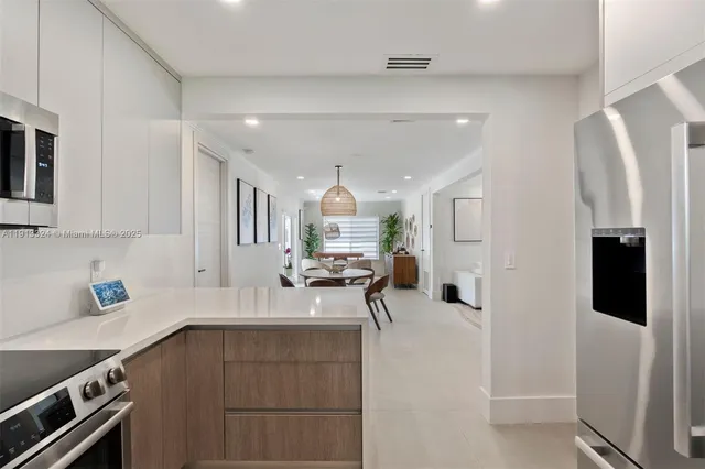 a kitchen with a sink appliances and cabinets