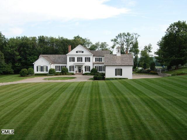 201 Wykeham Road Washington, CT 06793 - Photo 1 of 1 a front view of a house with yard and green space
