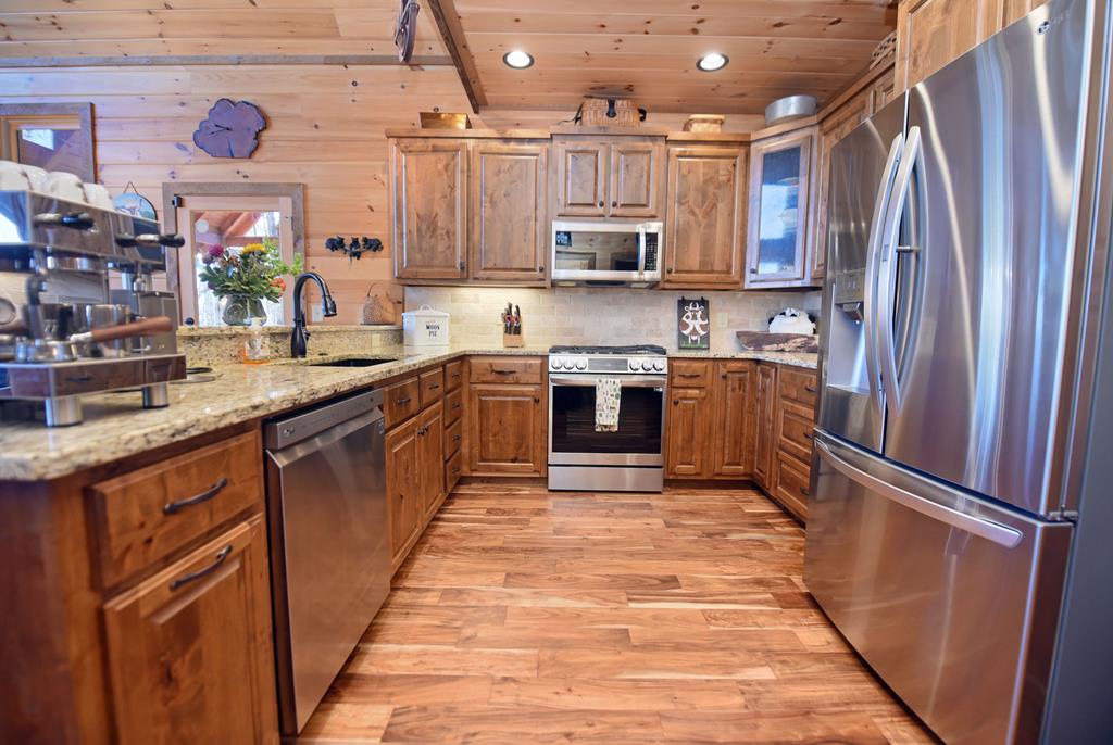 731 Native Trail Cherry Log, GA 30522 - Photo 24 of 54 a kitchen with stainless steel appliances granite countertop a refrigerator a sink dishwasher a stove top oven a sink and dishwasher