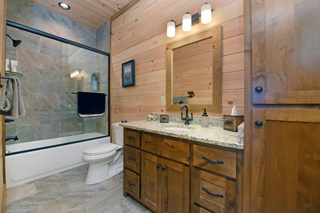 731 Native Trail Cherry Log, GA 30522 - Photo 49 of 54 a bathroom with a granite countertop sink toilet and shower