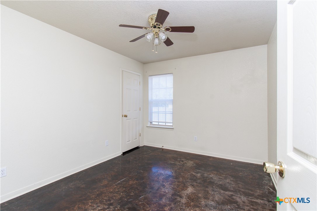 1611 Ute Trail, Unit B Harker Heights, TX 76548 - Photo 11 of 19 a view of a room with a ceiling fan and carpet